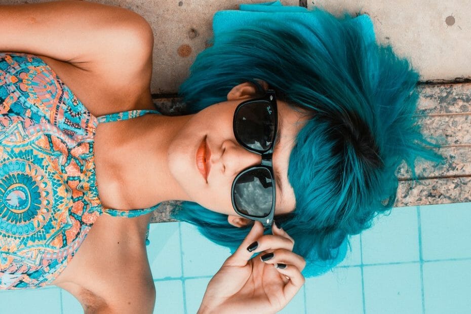 Woman with blue hair and sunglasses