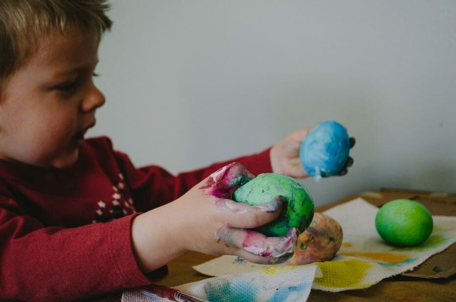 Creativity can be messy: little boy sculpting and painting