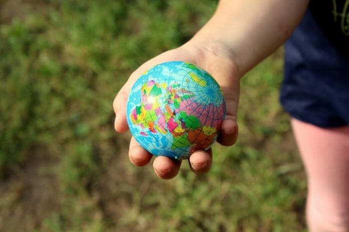 Child holding a small globe
